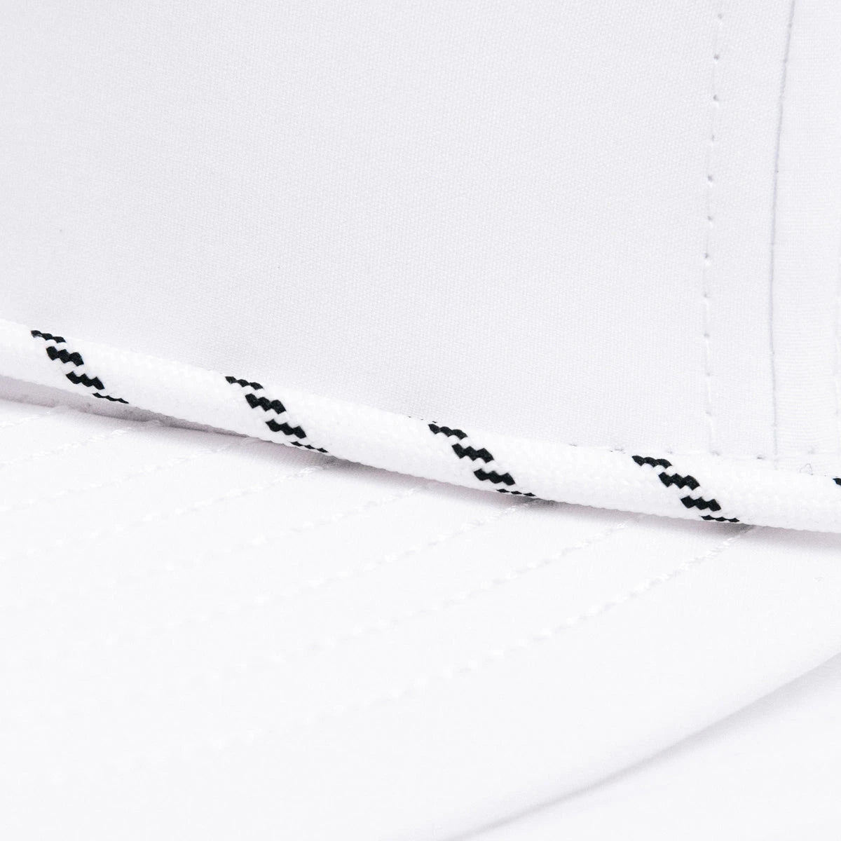 Close up detail of black/white thin rope detail on front of hat