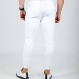 Person wearing white pants on a plain background