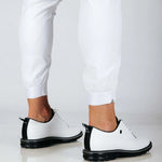 Back view close up of white pants and cuffed hems.