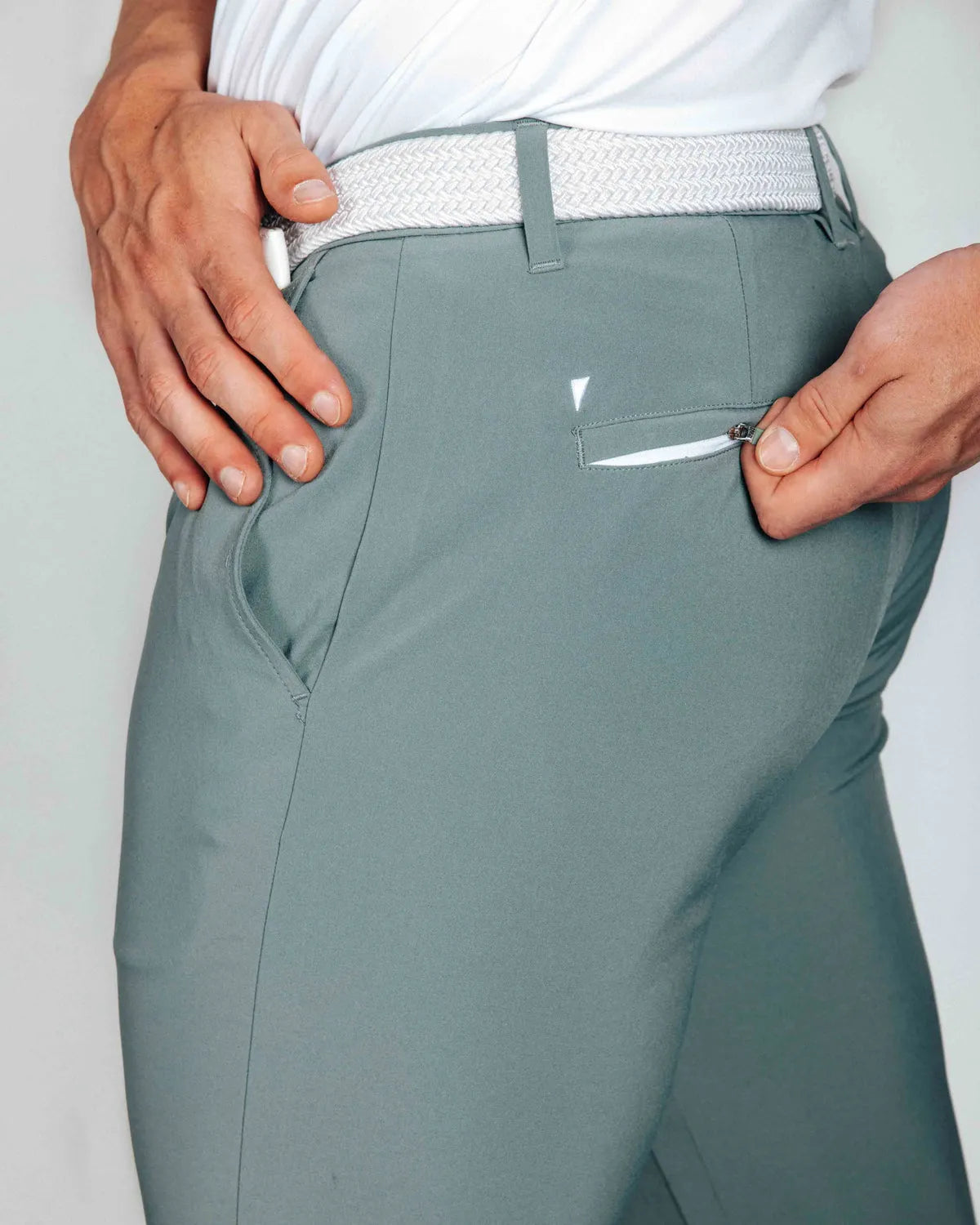 Smoke green pants with a white belt and a back zip pocket