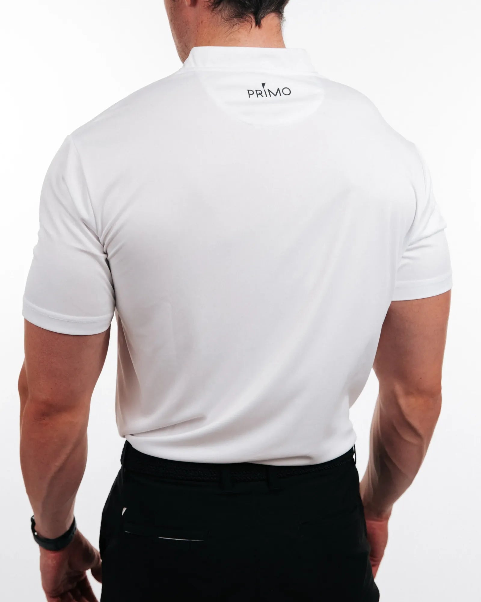 Person wearing a white polo shirt with 'PRIMO' logo on the back, standing against a plain background.