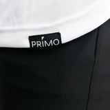 Close-up of a black garment with a Primo label on a white background