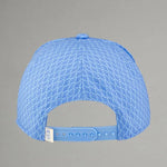 Blue cap with textured pattern on a gray background