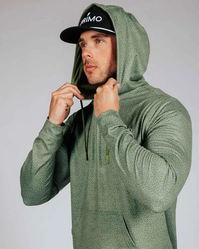 Man wearing green hoodie with hood on. Model is shown against a grey background