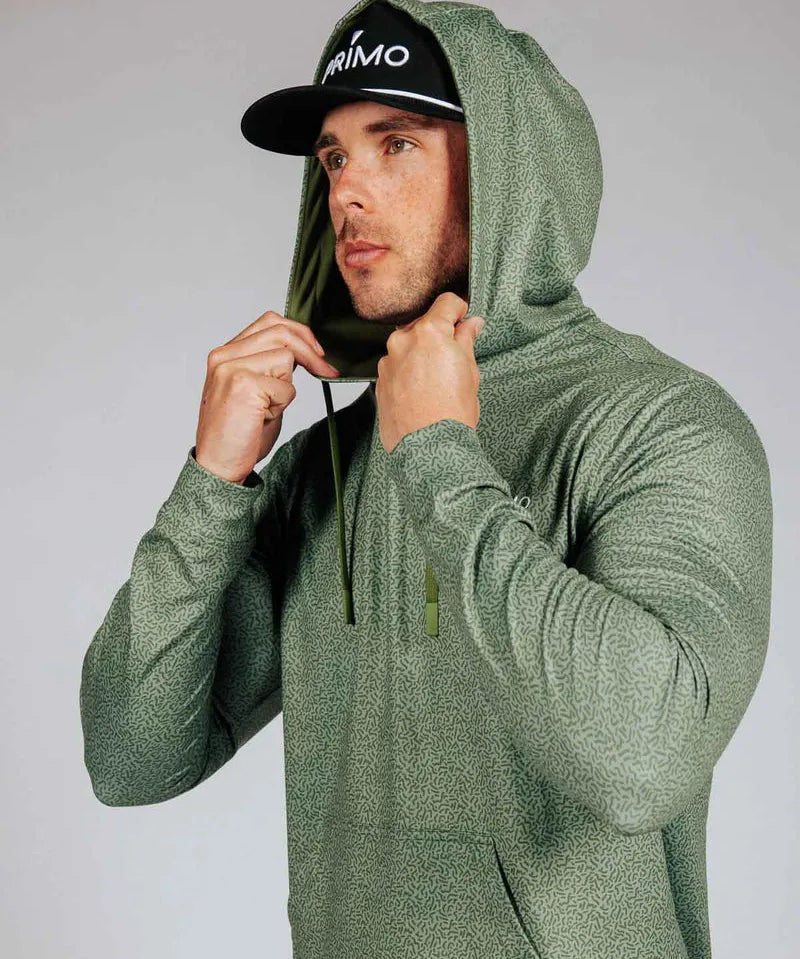 Man wearing green hoodie with hood on. Model is shown against a grey background