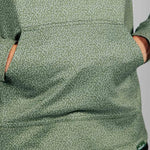 Close up detail of green hoodie with geometric pattern