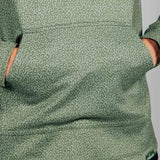 Close up detail of green hoodie with geometric pattern