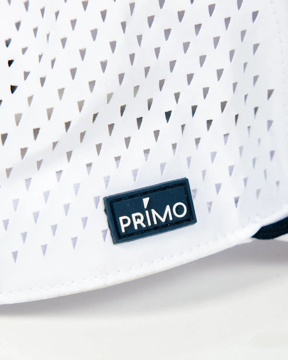 Close up of Primo rubber label sewn to outside of hat
