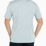 Man wearing a light blue polo shirt on a white background