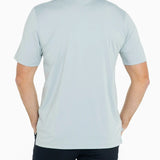 Man wearing a light blue polo shirt on a white background