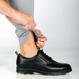 Person showing off hem zip for easy access. Also wearing black shoes.