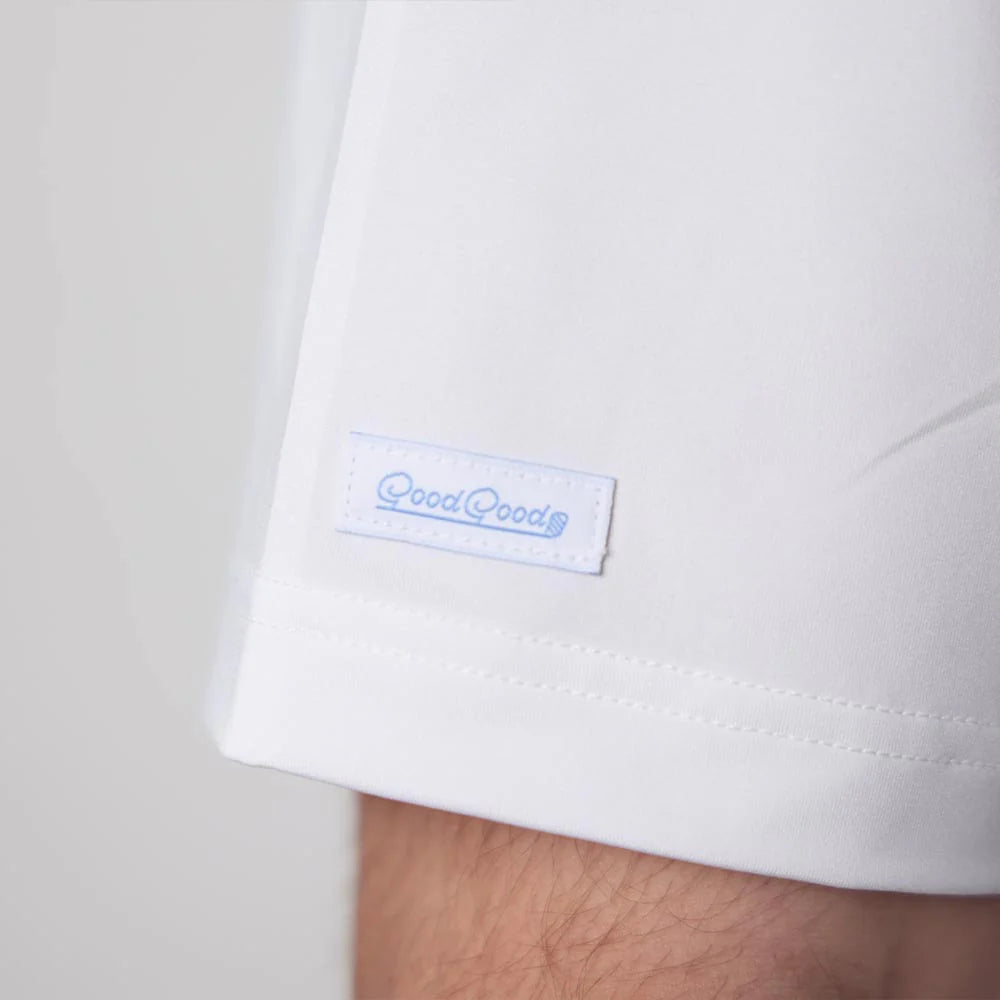 Close-up of a white shirt with a blue logo on a light gray background